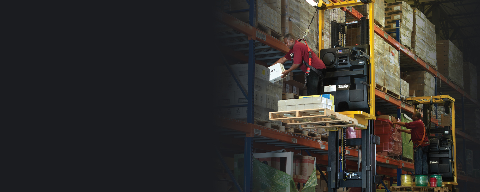 Man harnessed to a Yale order picker works in a warehouse